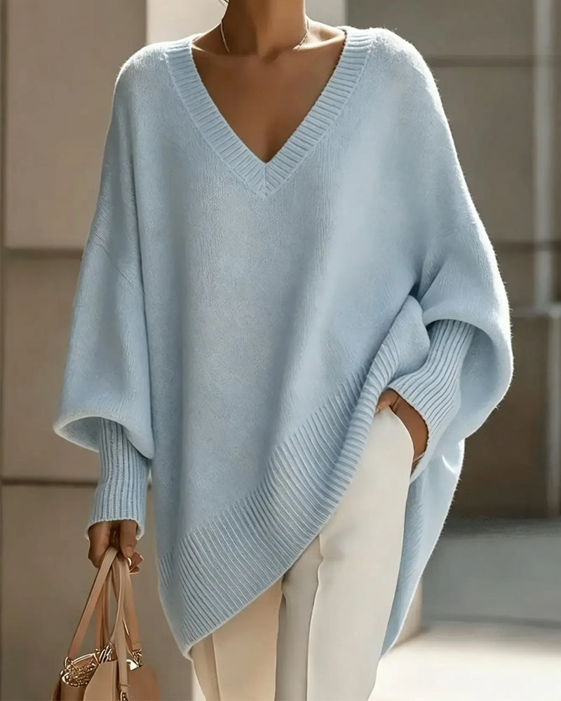 Women's oversized V-neck jumper with batwing sleeves and asymmetric hem