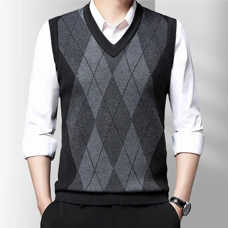 Men's sleeveless argyle V-neck sweater vest layered over a white shirt