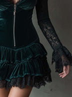 Women's green velvet mini dress with black lace sleeves and tiered ruffle skirt