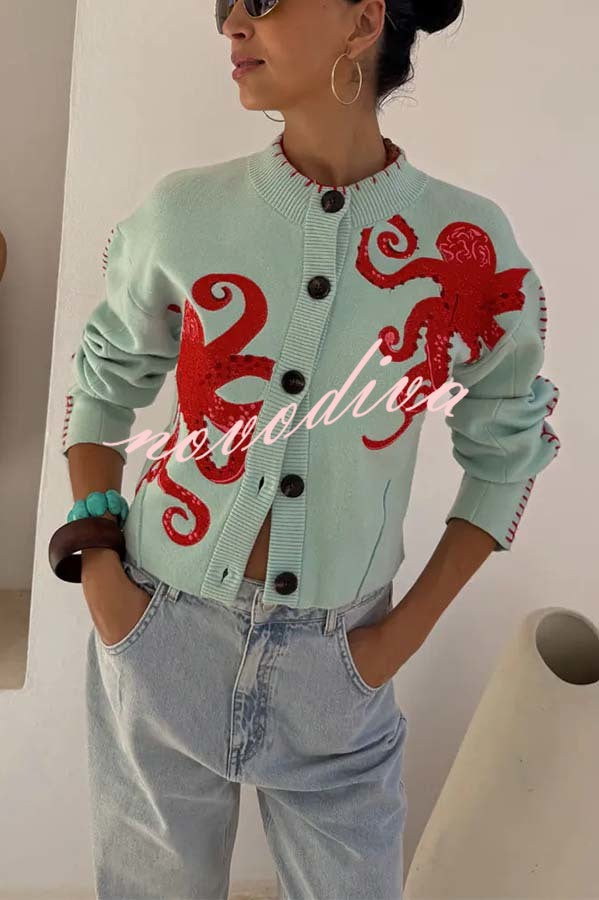 Women's pale blue cardigan with red octopus graphics and button front