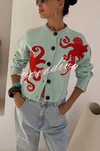 Women's pale blue cardigan with red octopus graphics and button front