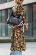 Woman wearing a leopard print long sleeve midi trench coat