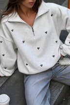 Women's light gray half-zip sweatshirt with black heart studs