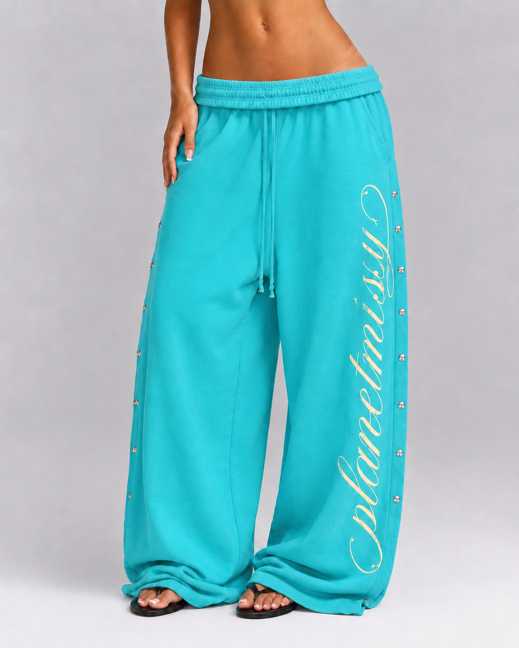 Women's turquoise wide leg jogger trousers with side snaps and drawstring waist