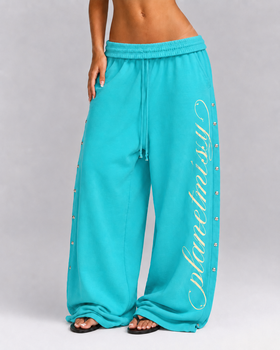 Women's turquoise wide leg jogger trousers with side snaps and drawstring waist