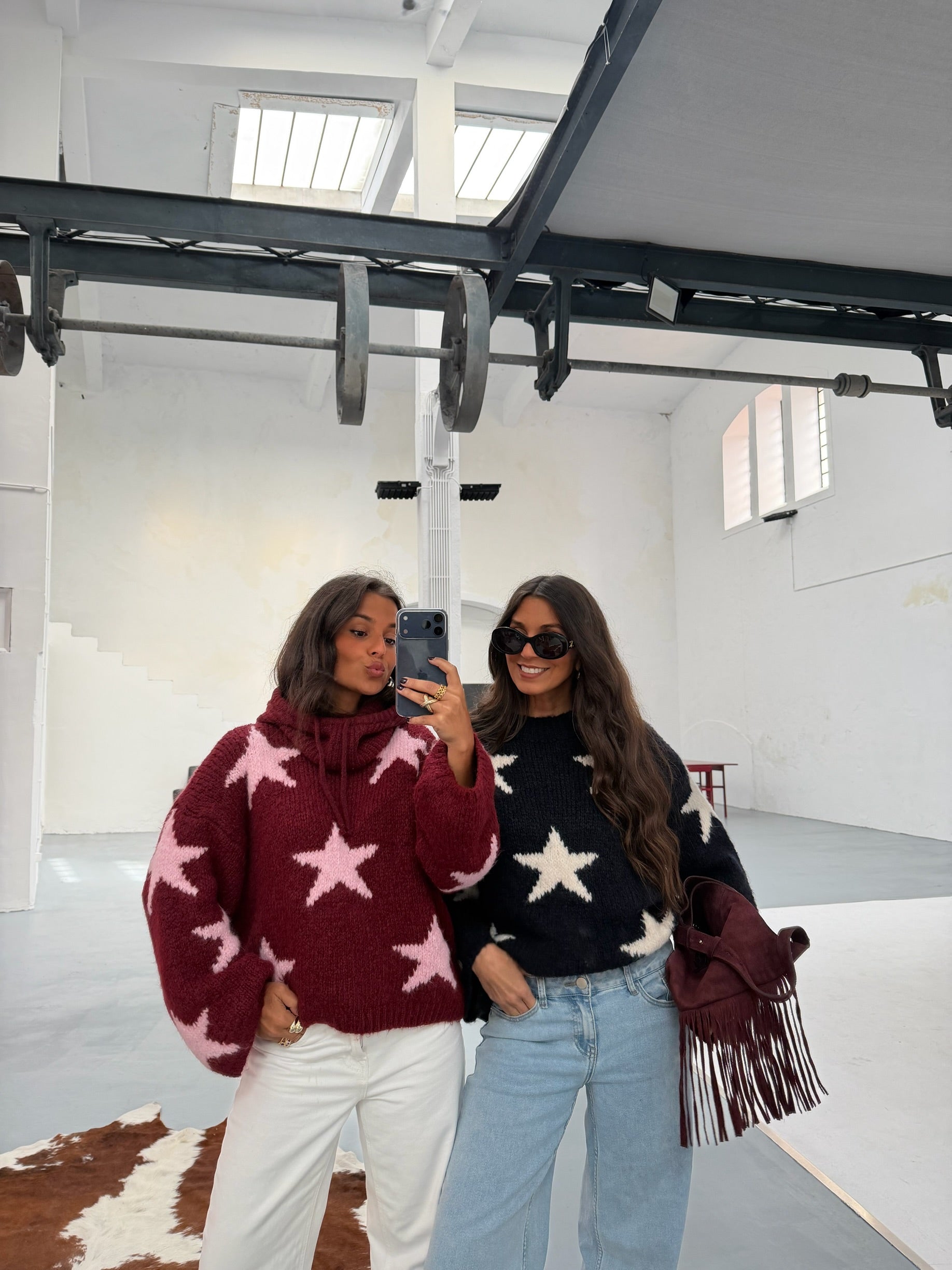 Women's burgundy sweater with contrasting pink star pattern and long sleeves
