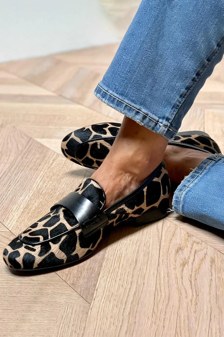 Women's cow print loafers with black strap and round toe