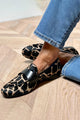 Women's cow print loafers with black strap and round toe
