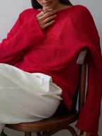Women's open-knit oversized sweater with wide sleeves and crew neck