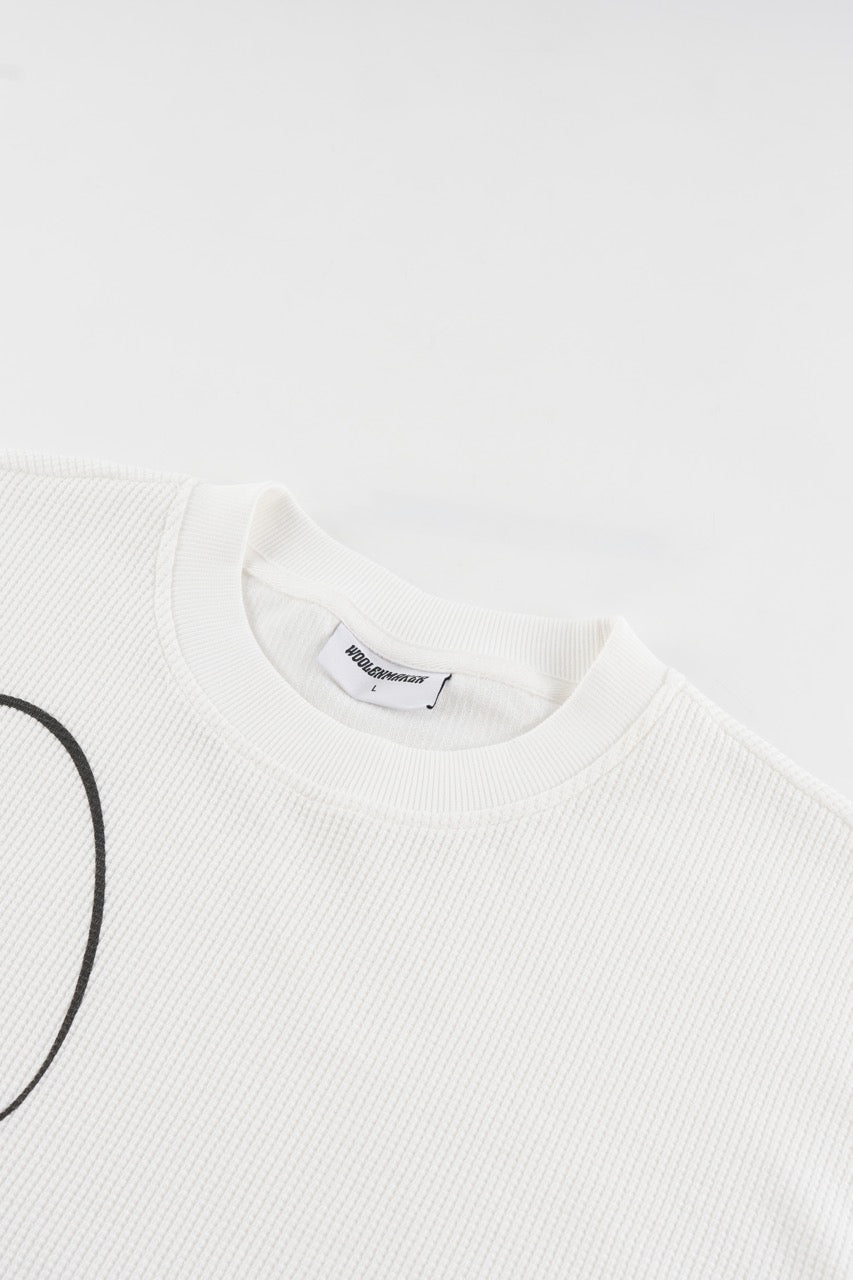 White waffle sweatshirt with black script graphic and long sleeves