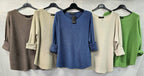 Women's fine-knit top with crew neckline, long sleeves, rolled cuffs and curved hem