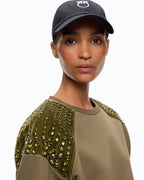 Women's green crew neck sweatshirt with embellished shoulder panels
