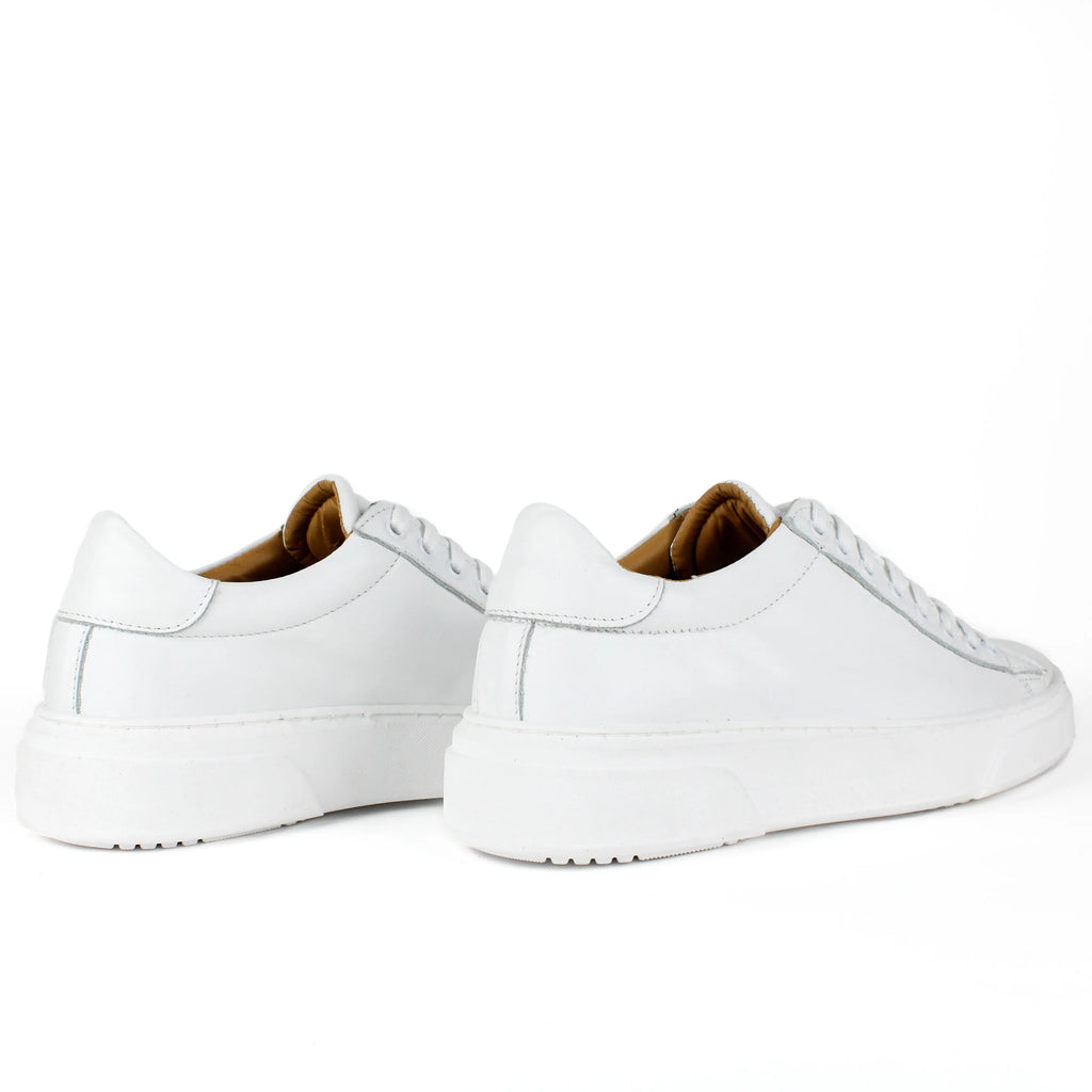 White low-top leather sneakers with laces and thick flat soles
