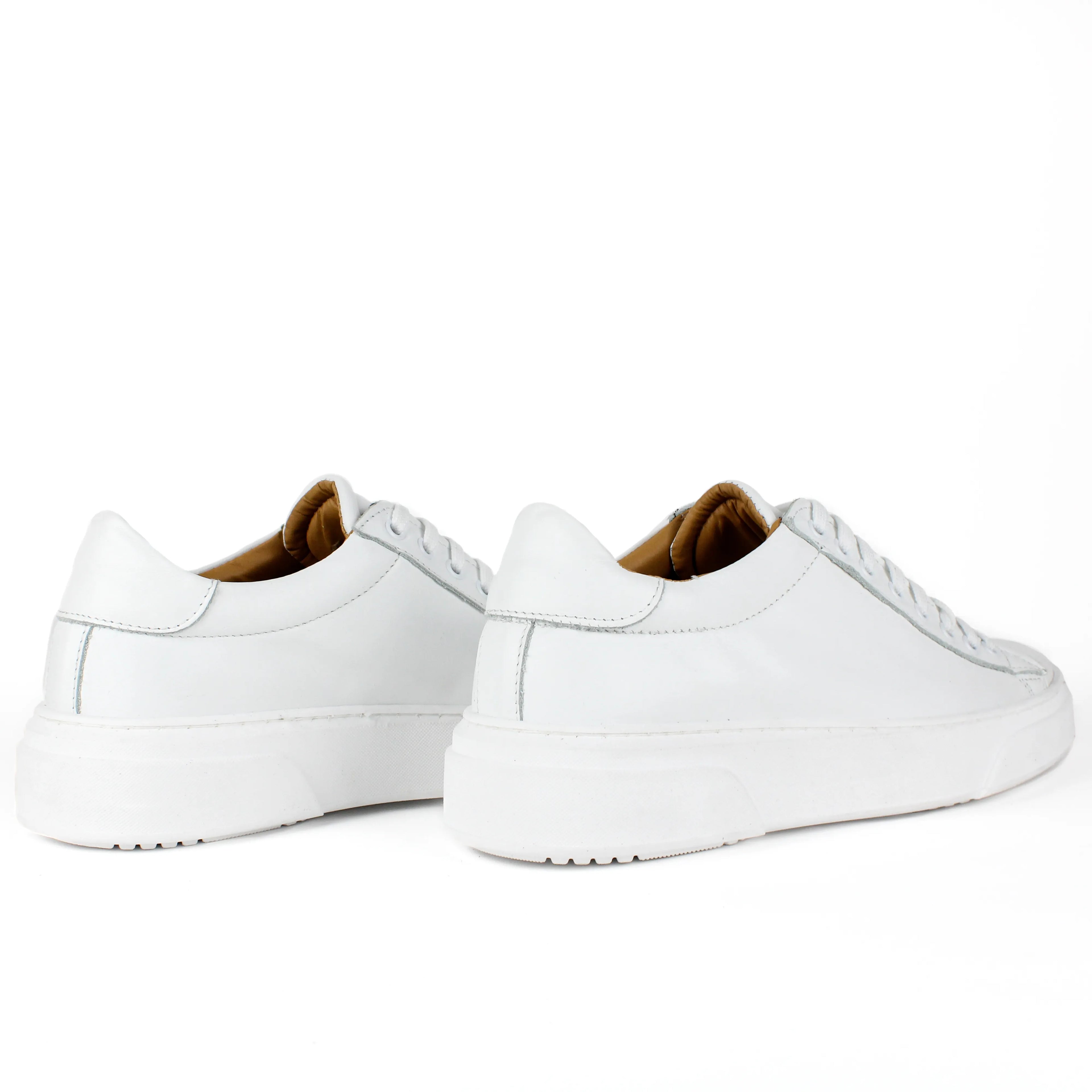 White low-top leather sneakers with laces and thick flat soles