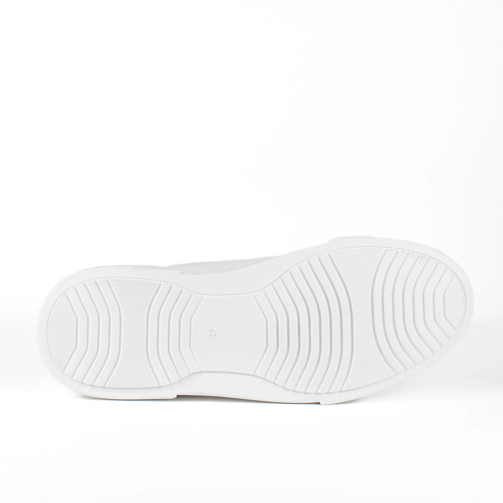 White low-top leather sneakers with laces and thick flat soles