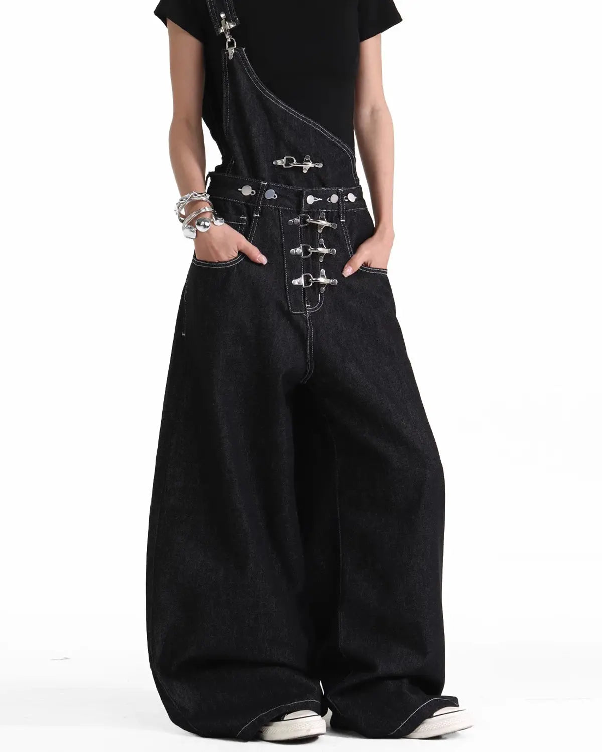 Black denim bib jeans with asymmetric shoulder strap, buckle details and wide legs