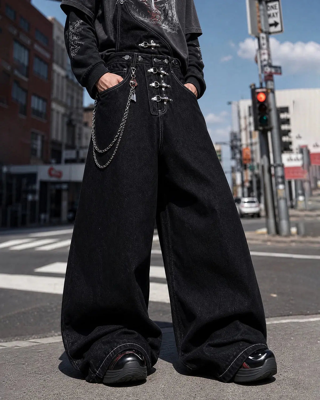 Black denim bib jeans with asymmetric shoulder strap, buckle details and wide legs