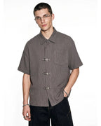 Men's dark gray waffle shirt with short sleeves and metal clasps