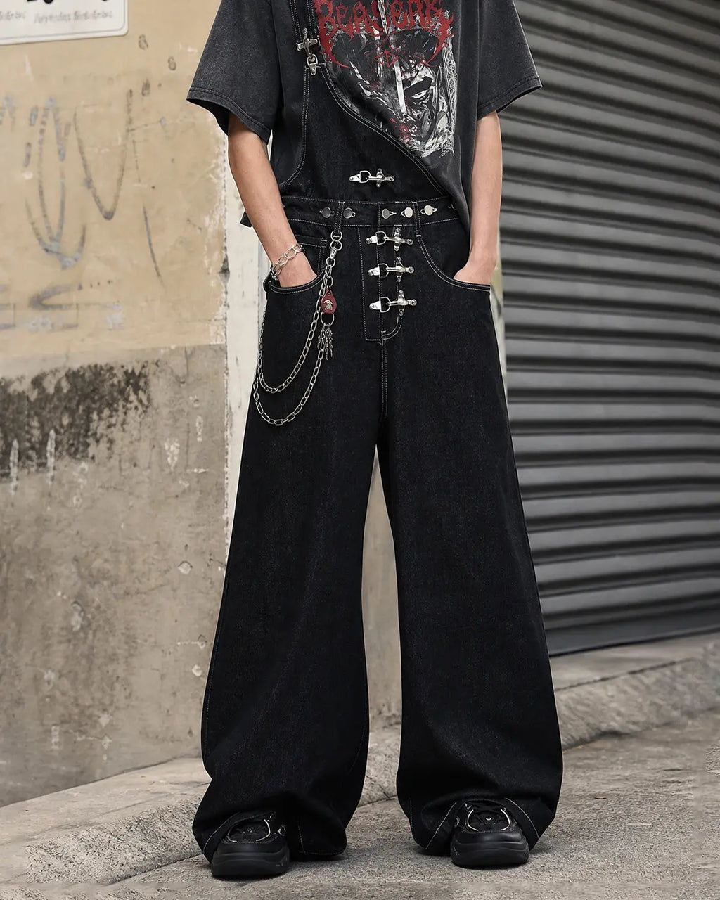 Black denim bib jeans with asymmetric shoulder strap, buckle details and wide legs