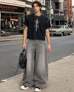 Light gray washed wide-leg jeans with rhinestone lower-leg detail