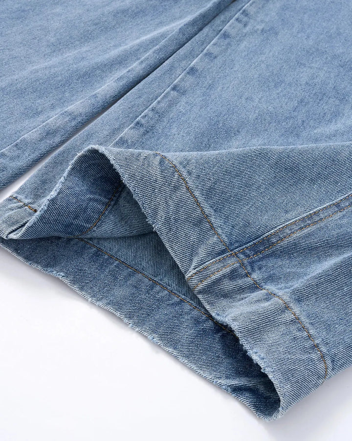 Light blue barrel jeans with script graphic on the left leg