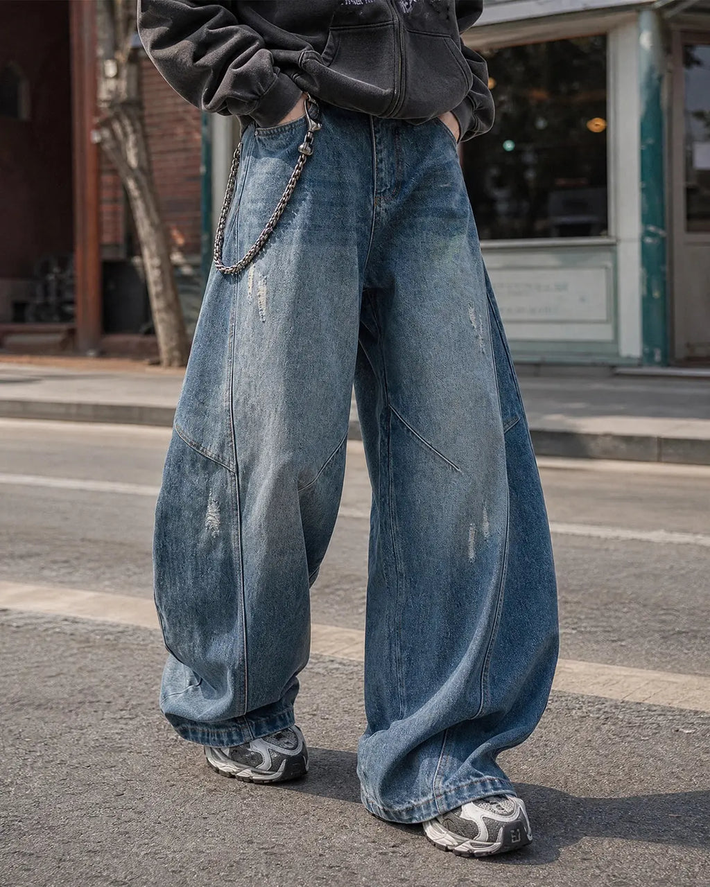 Distressed baggy jeans with wide legs and stitched panel details