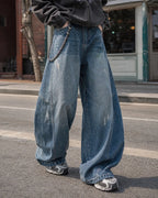 Distressed baggy jeans with wide legs and stitched panel details