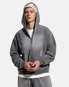 Men's grey acid-wash zip-up hoodie with hood, graphic print and front pockets