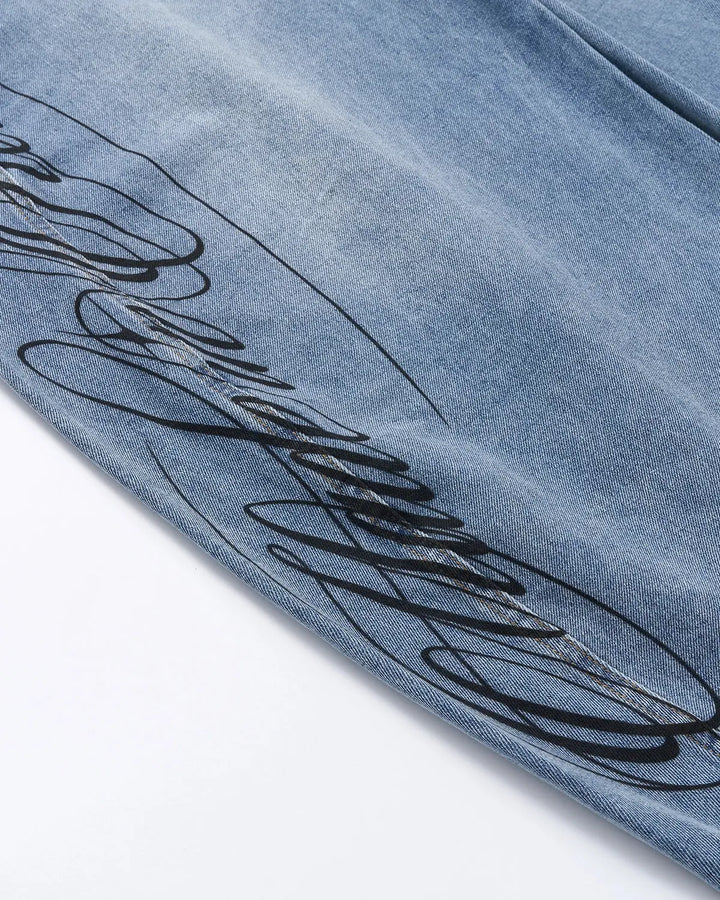 Light blue barrel jeans with script graphic on the left leg