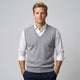 Men's sleeveless V-neck jumper layered over a collared shirt