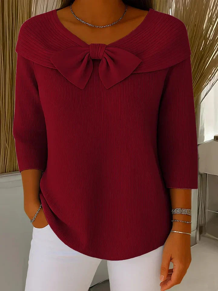 Women's ribbed sweater with a large bow and three-quarter sleeves