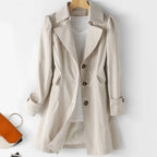 Women's belted trench coat with wide lapels and flap pockets