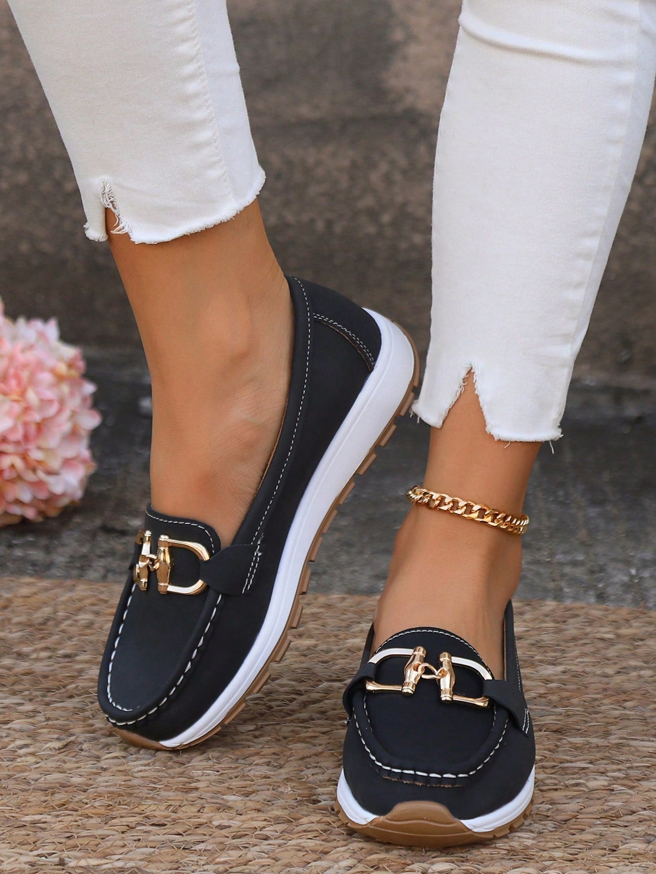Women's flat loafers with decorative metal buckles and rounded toes