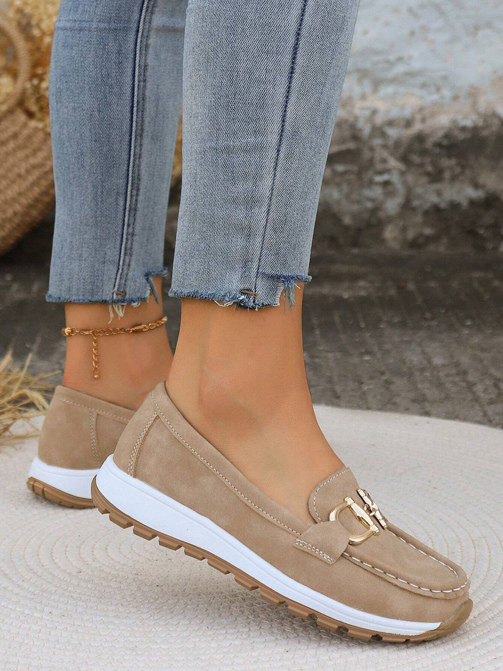 Women's flat loafers with decorative metal buckles and rounded toes