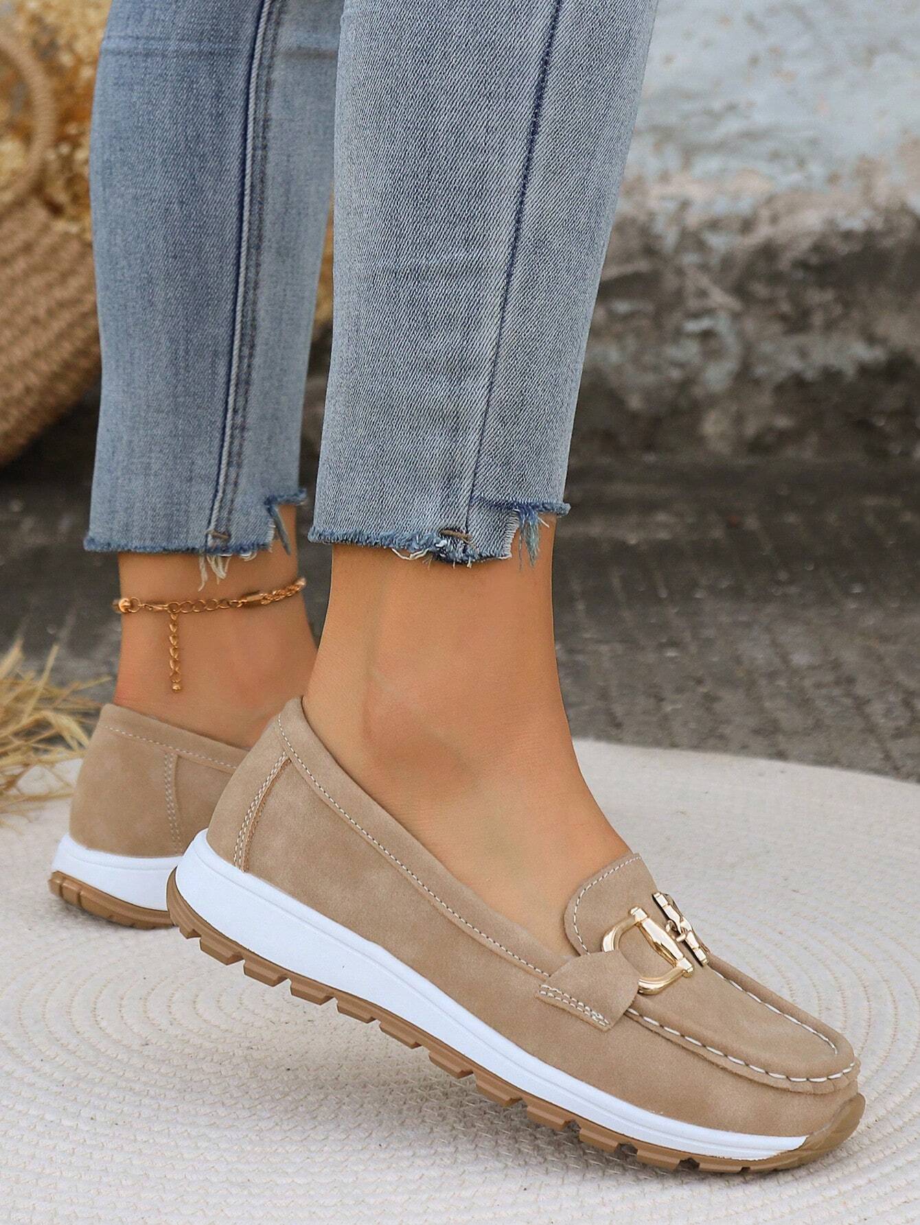 Women's flat loafers with decorative metal buckles and rounded toes