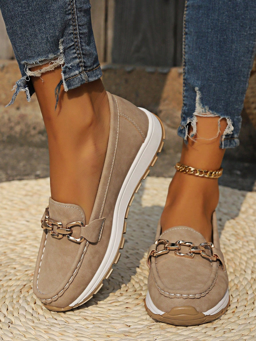 Women's flat loafers with decorative metal buckles and rounded toes
