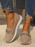 Women's flat loafers with decorative metal buckles and rounded toes