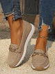 Women's flat loafers with decorative metal buckles and rounded toes