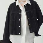 Women's cropped dark denim jacket with long sleeves and front pockets
