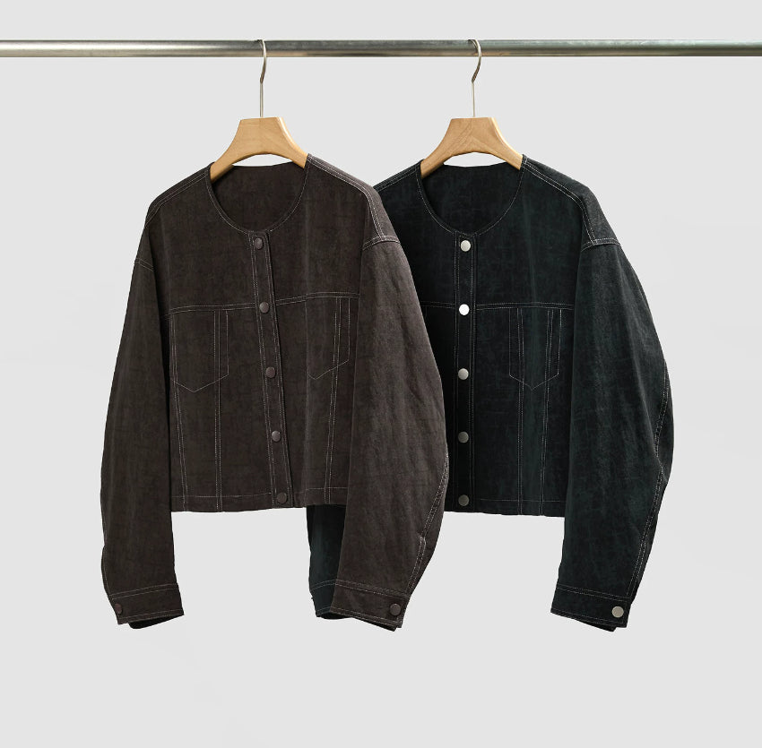 Women's cropped dark denim jacket with long sleeves and front pockets