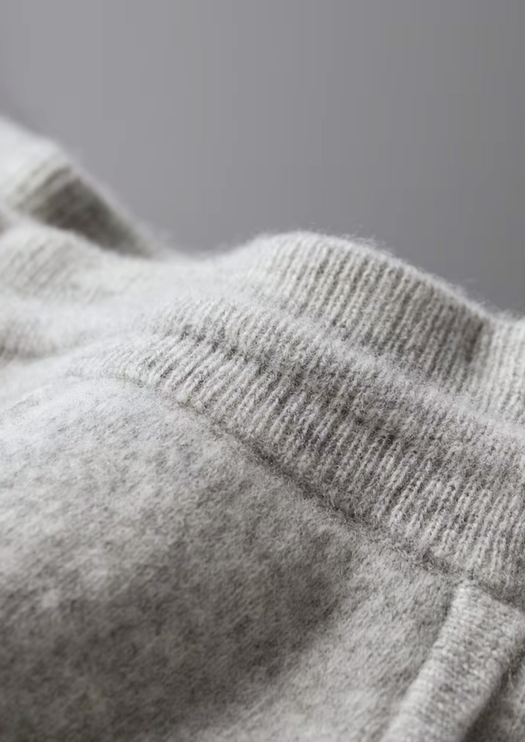 Men's two-tone grey knit tracksuit set with a zip jacket and drawstring trousers