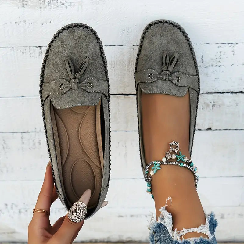 Women's flat moccasin loafers with decorative lacing and rounded toes