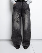 Women's black wide-leg jeans with graphic printed panels and flap pockets