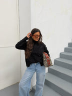Women's black mock neck sweater with button details