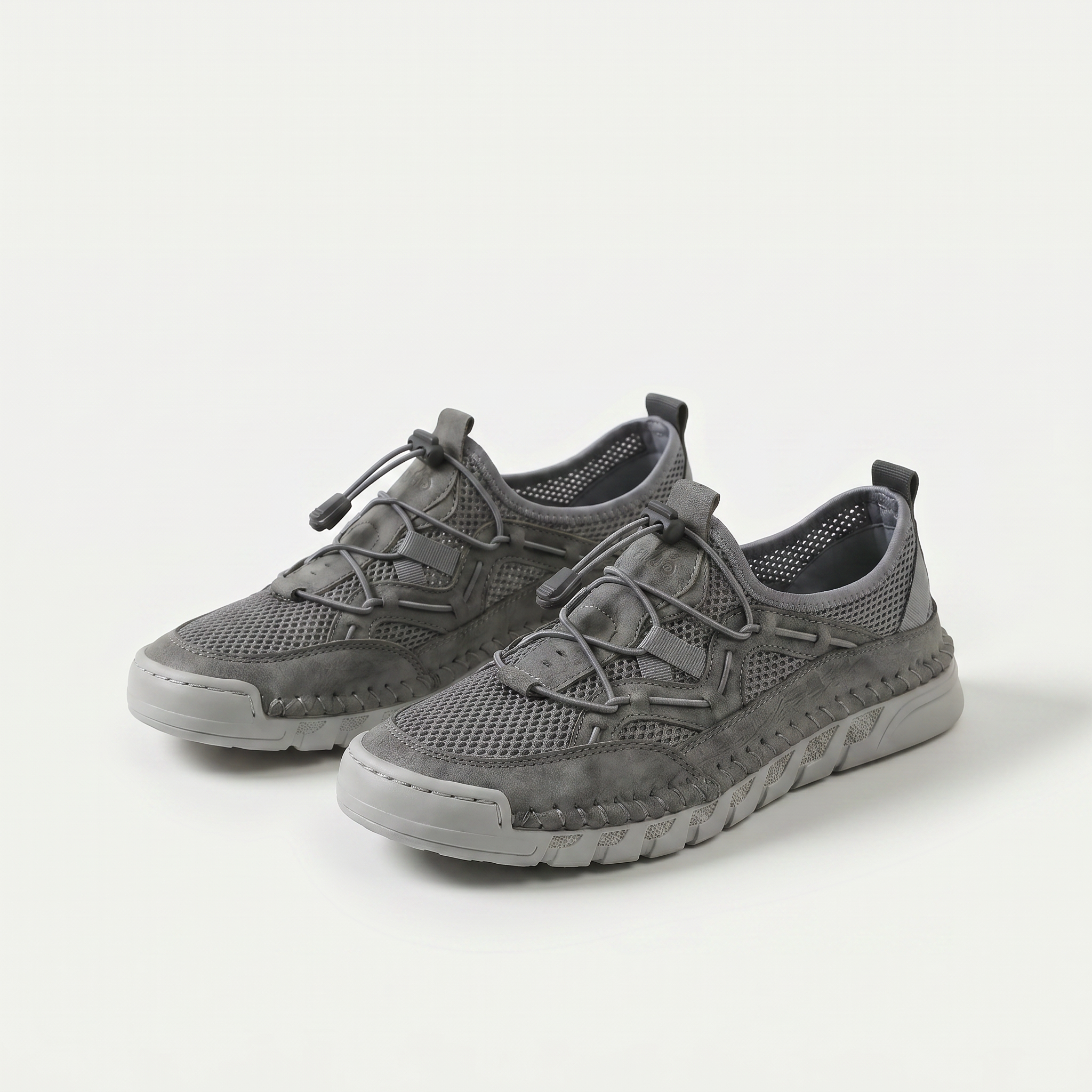 Mesh sneakers with toggle laces and segmented flat soles
