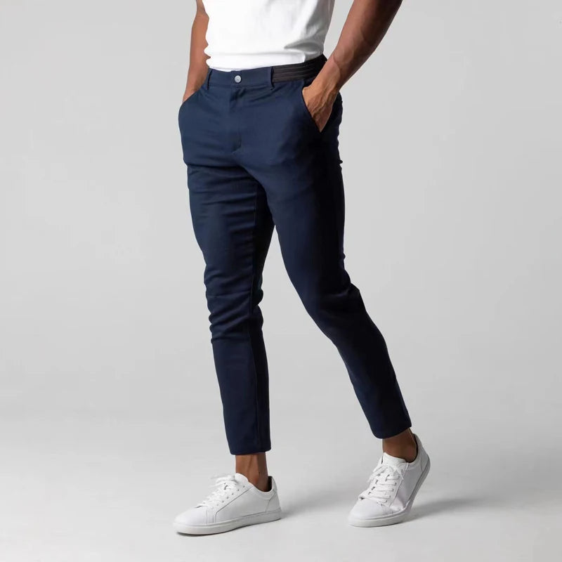 Men's slim tapered chinos trousers shown in black and navy with side pockets