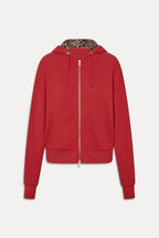 Women's red zip-up hoodie with animal print lined hood and front pockets