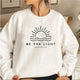 Women's crew neck sweatshirt with sun and wave graphic and Be the Light text