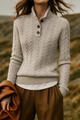 Women's cable knit sweater with buttoned stand collar and long sleeves