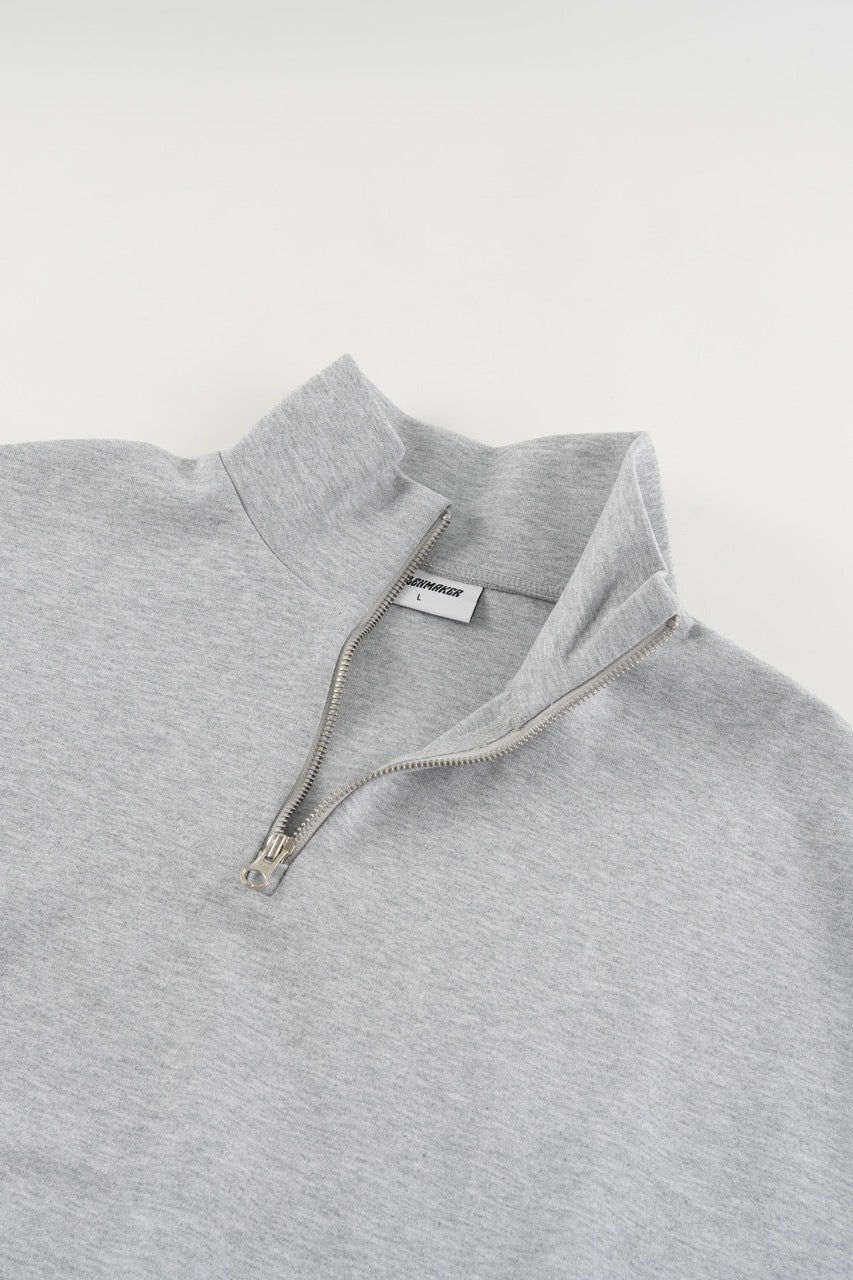 Gray cropped quarter-zip hoodie with mock neck and long sleeves